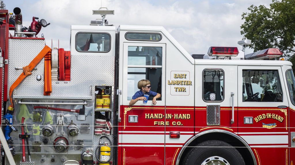 Junior Volunteer with Hand-in-Hand Fire Truck